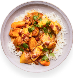 A plate of tangerine miso chicken over white rice